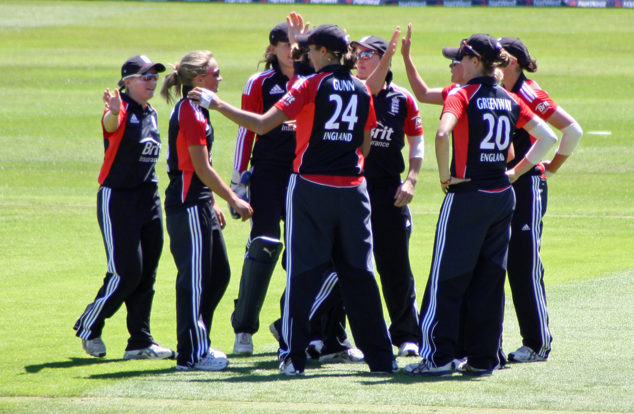 English female cricket team celebrating their victory