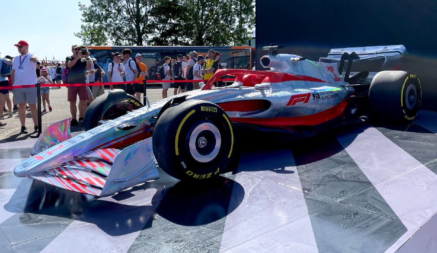 A Formula 1 car with white body paint and red stripes.