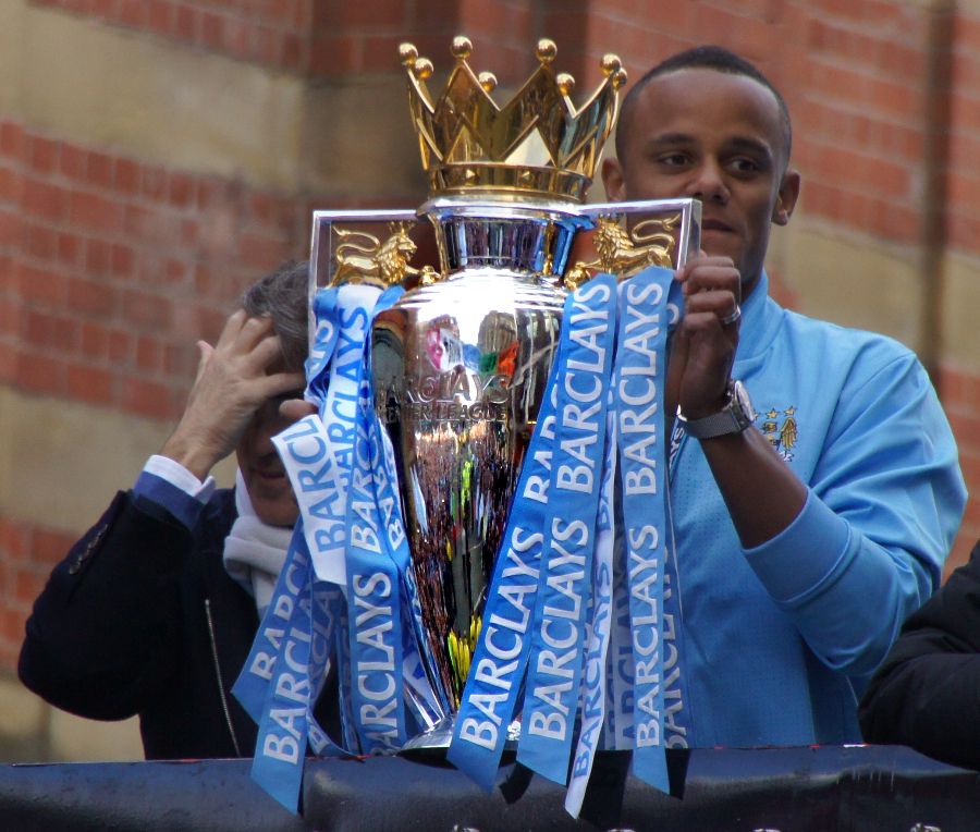 Vincent Kompany holding the 2012 Premier League trophy.