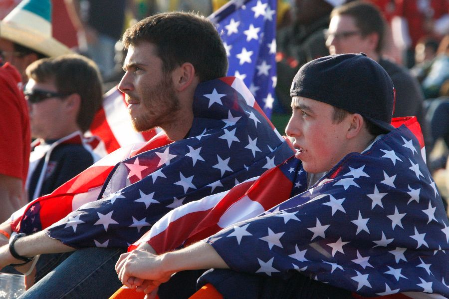Two soccer fans wearing the flag of USA.