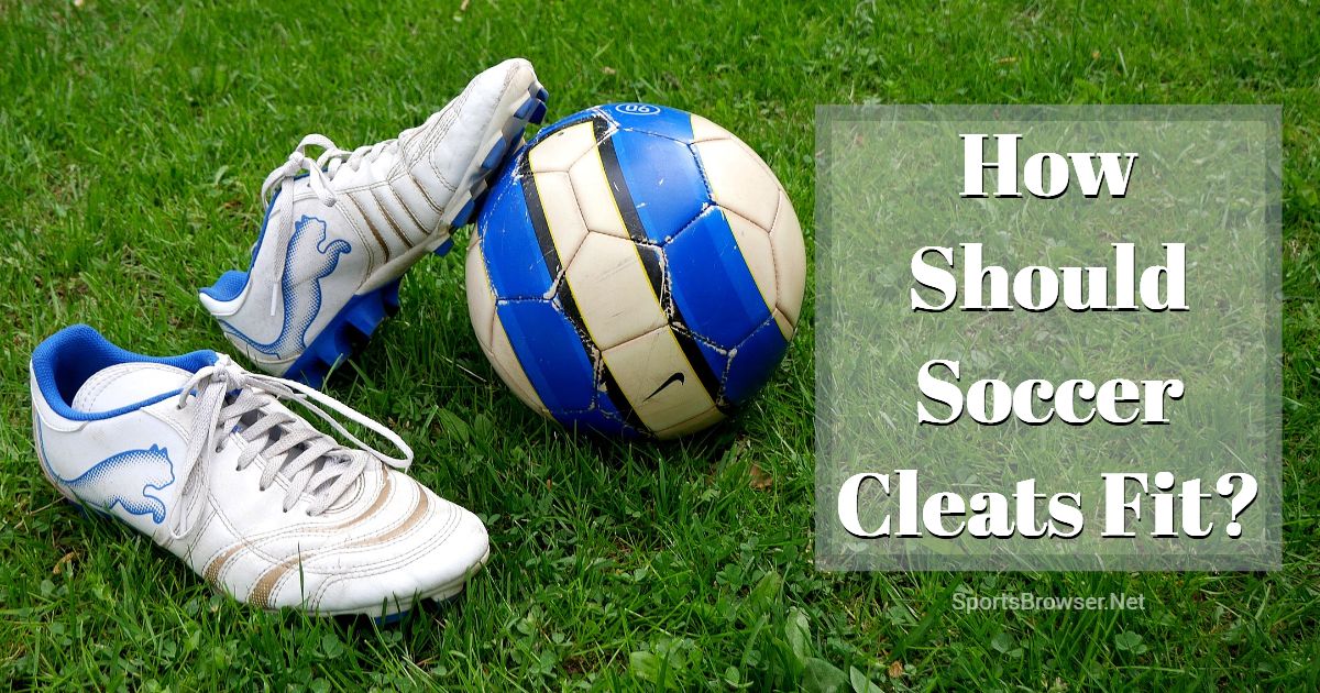 A pair of white soccer cleats and a blue stripped ball, featured on a blog about how soccer cleats should fit.