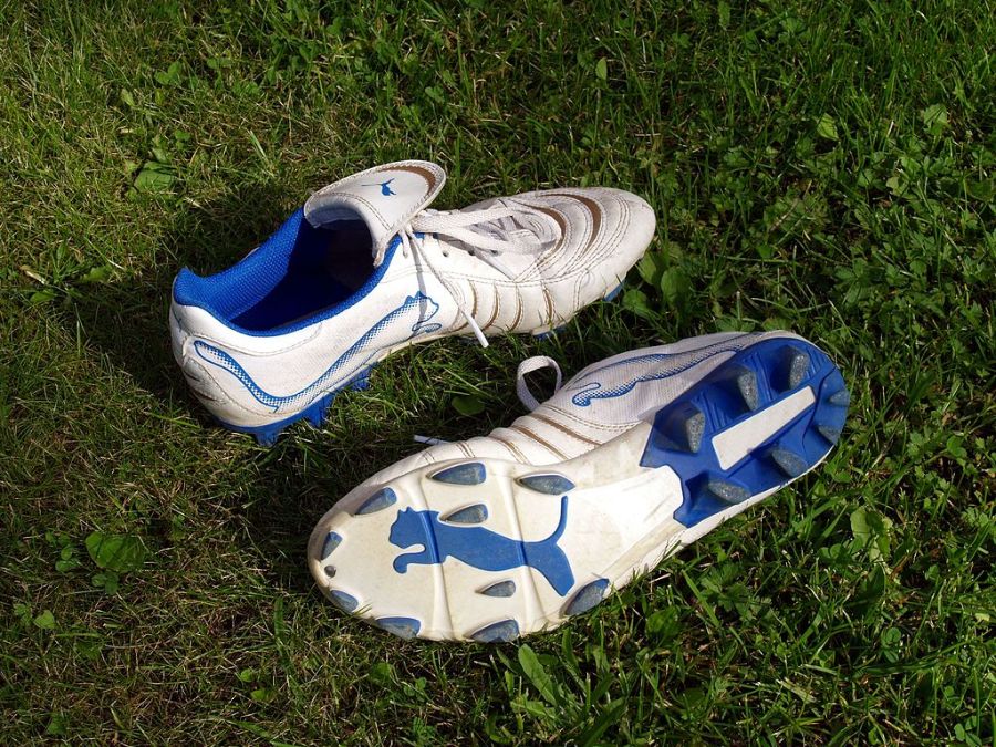 A pair of white and blue soccer cleats from Puma.